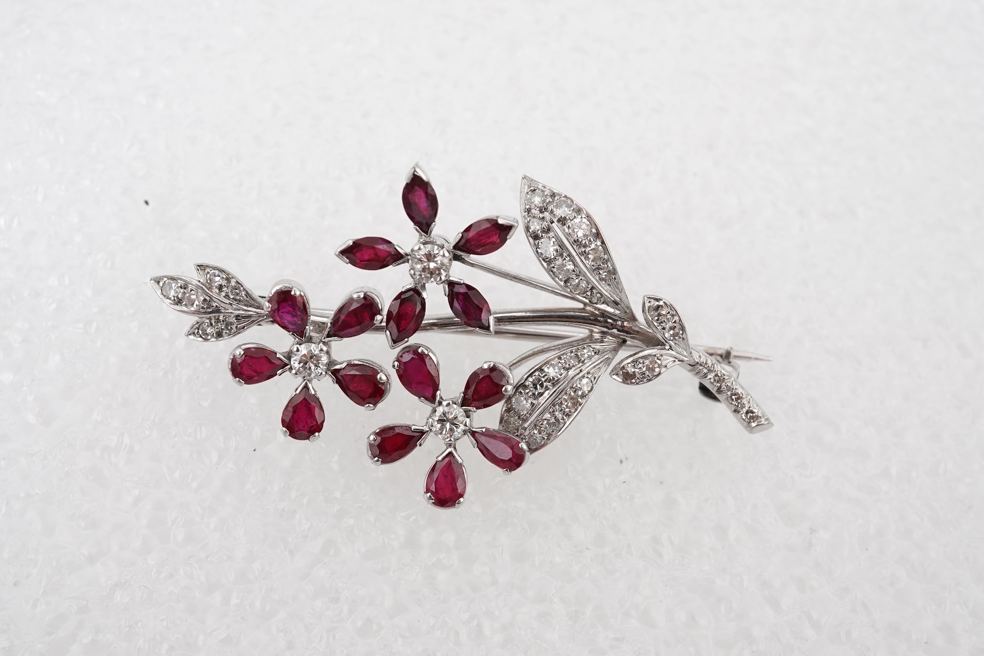 A ruby and diamond floral spray brooch